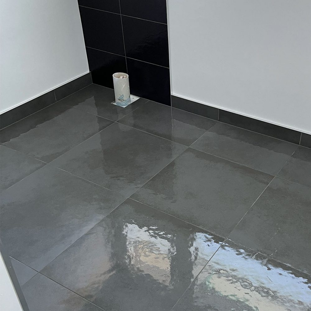 Behind toilet tiling